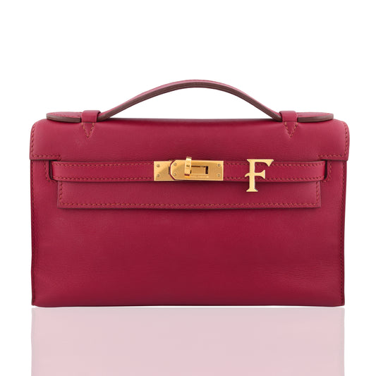 Pink handbag with gold clasp on a white background, collection-preview