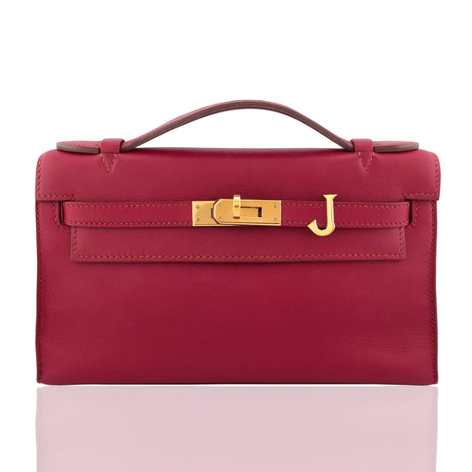 Red handbag with gold clasp on a white background, collection-preview