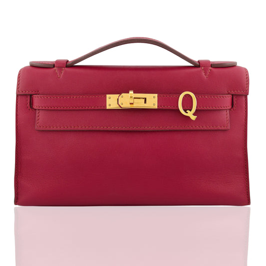 Red handbag with gold clasp on a white background, collection-preview