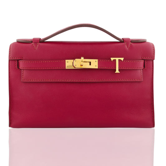 Red handbag with gold clasp on a white background, collection-preview