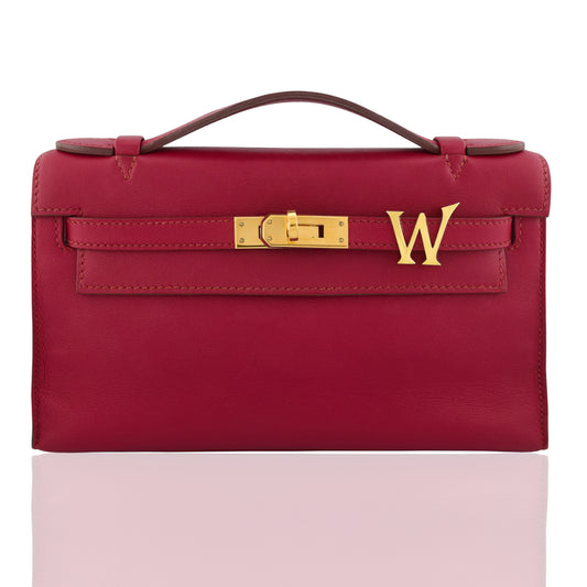 Red handbag with gold clasp and 'W' logo on a white background, collection-preview