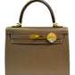 Brown handbag with gold clasp and emblem on a white background, collection-preview