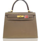Brown handbag with gold hardware and a red and white tag on a white , collection-previewbackground