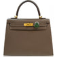 Brown handbag with gold hardware and a green clasp on a white background, collection-preview