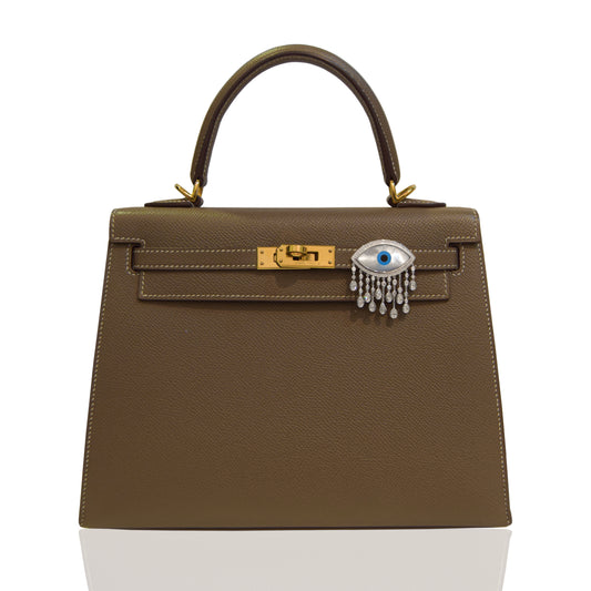 Brown handbag with a decorative clasp on a white background, collection-preview