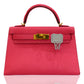 Pink handbag with gold clasp on a white background, collection-preview