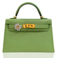 Green handbag with floral detail on a white background, collection-preview