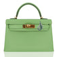 Green handbag with gold hardware on a white background, collection-preview