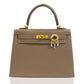 Brown handbag with decorative clasp on a white background, collection-preview