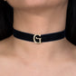 Navy blue choker with a gold 'G' clasp worn by a person