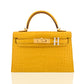 Yellow crocodile-patterned handbag with gold hardware on a white background, collection-preview