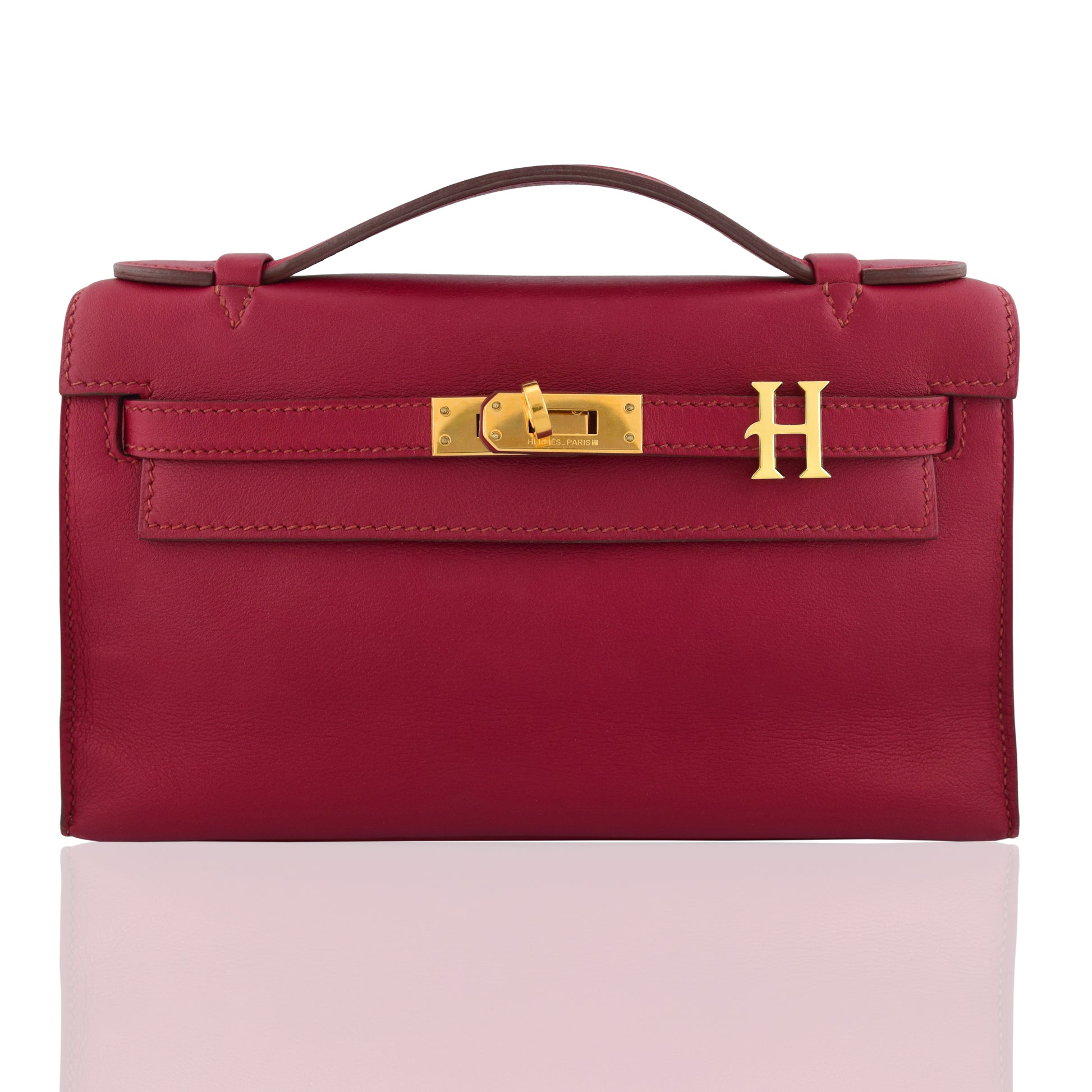 Red handbag with gold hardware on a white background, collection-preview