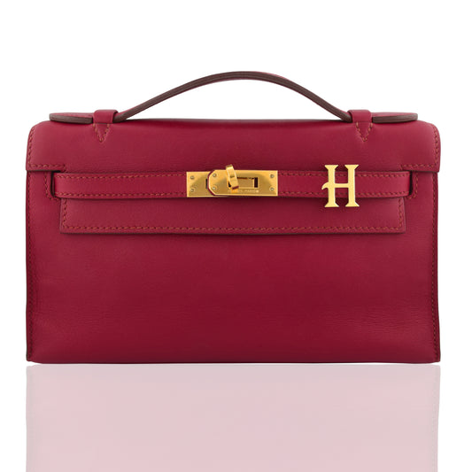 Red handbag with gold hardware on a white background, collection-preview