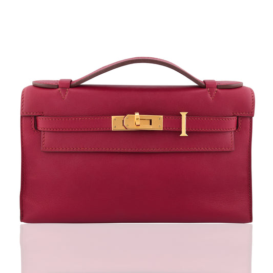 Red handbag with gold clasp on a white background, collection-preview