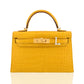 Yellow crocodile skin handbag with gold hardware on a white background, collection-preview