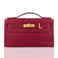 Red handbag with gold hardware on a white background, collection-preview
