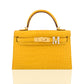 Yellow crocodile skin handbag with gold hardware on a white background, collection-preview