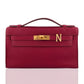 Red handbag with gold clasp and logo on a white background, collection-preview