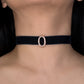 Black choker with a rose gold buckle worn by a person