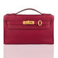 Red handbag with a gold clasp on a white background, collection-preview