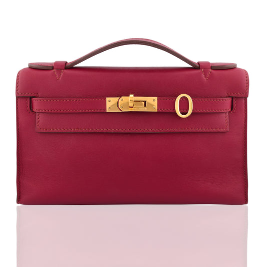 Red handbag with a gold clasp on a white background, collection-preview