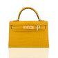 Yellow crocodile skin handbag with gold hardware on a white background, collection-preview