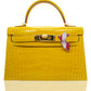 A yellow handbag with a crocodile pattern featuring abijoux accessory with Peru flag attached to it, collection-preview.