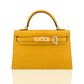 Yellow crocodile-patterned handbag with a gold clasp on a white background, collection-preview