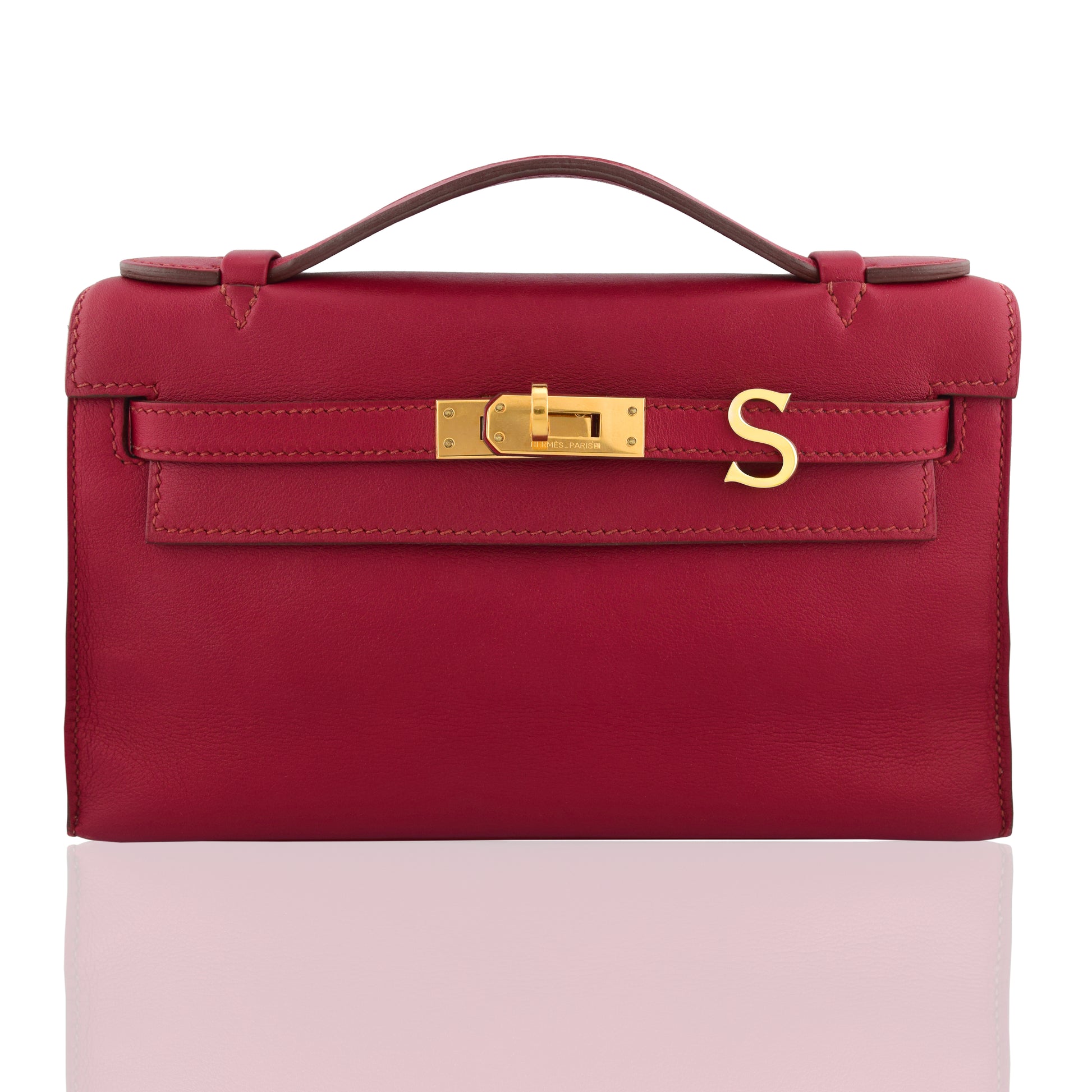 Red handbag with gold clasp on a white background, collection-preview