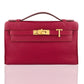 Red handbag with gold clasp on a white background, collection-preview