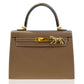 Brown handbag with gold hardware and tiger clasp on a white background, collection-preview