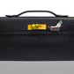 A black handbag with a UAE flag detail on the front, featuring a gold clasp and adorned with a diamond brooch, collection-preview.