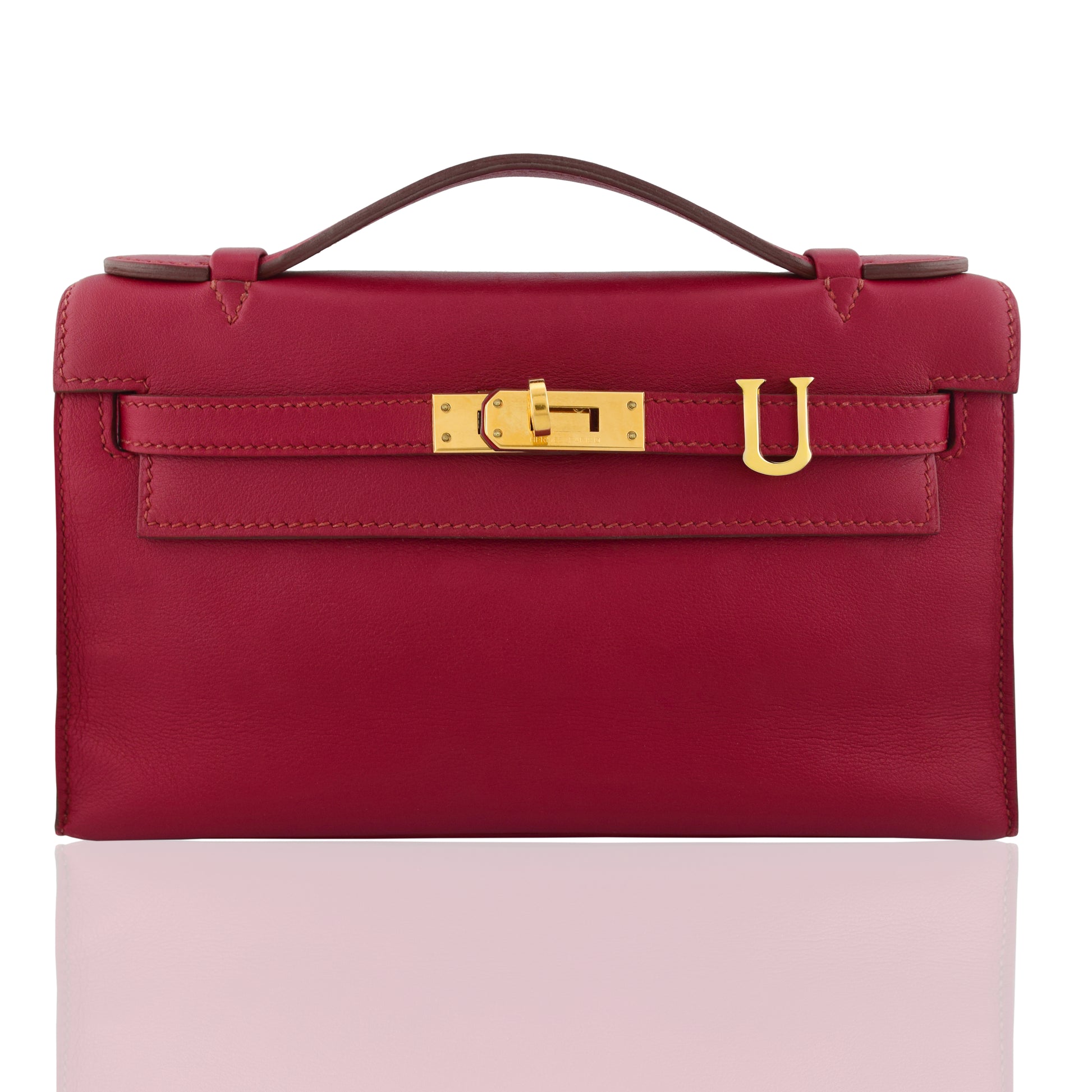 Red handbag with a gold clasp on a white background, collection-preview