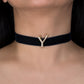 Black choker necklace with a gold 'Y' pendant on a person's neck.