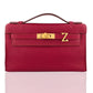 Red handbag with gold clasp on a white background, collection-preview