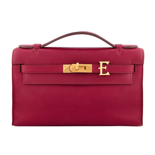 Red handbag with gold hardware on a white background, collection-preview